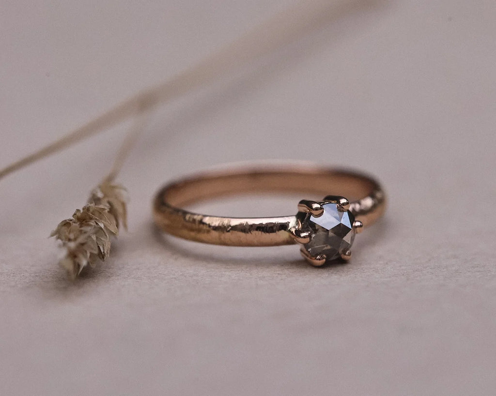 Low front view of grey rose-cut diamond horn texture ring