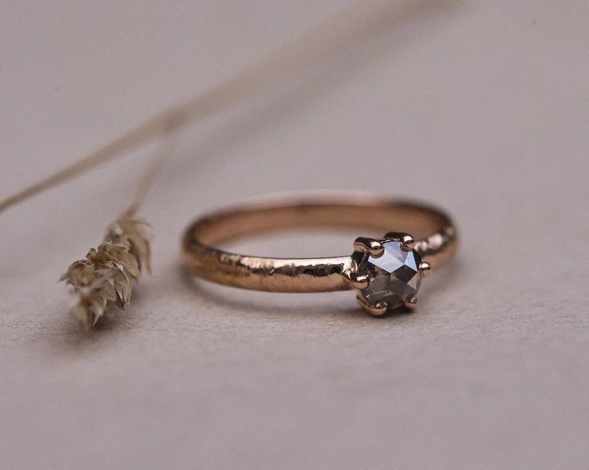 Low front view of grey rose-cut diamond horn texture ring