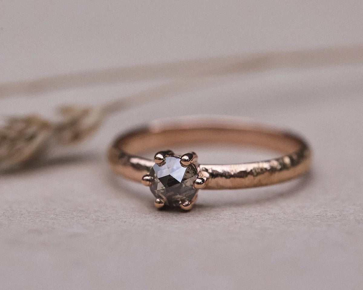  Close-up of natural grey rose-cut diamond set on rose gold textured band