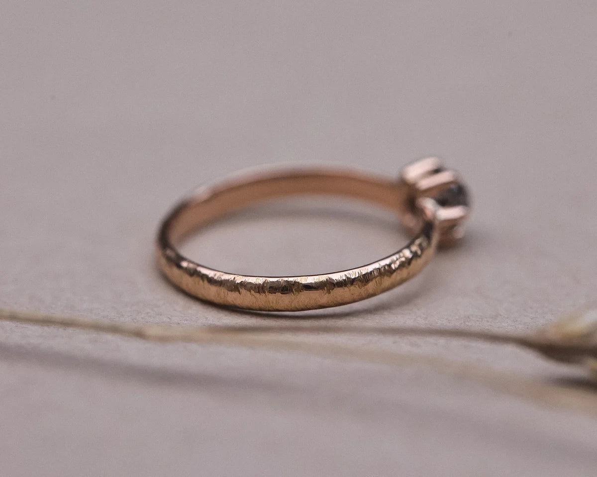 Angled profile of handmade horn texture ring in 18ct rose gold