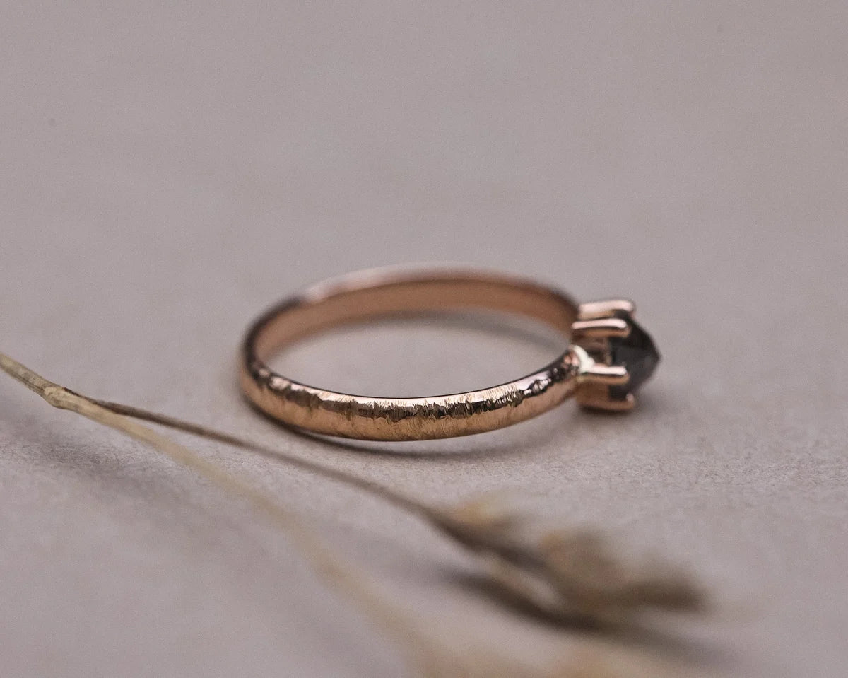 Close-up of rose gold horn texture band with grey diamond setting