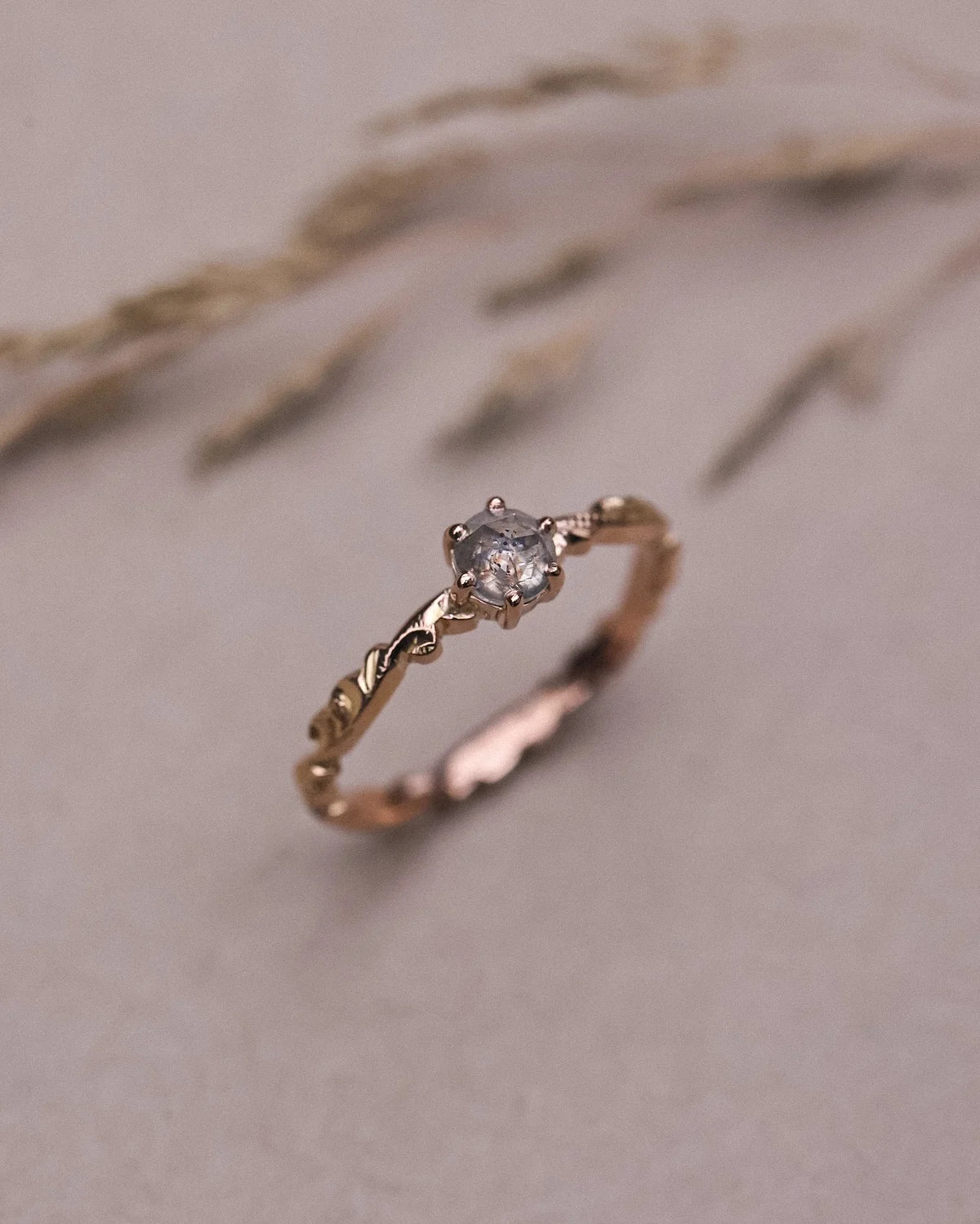 Angled close-up of pale grey rose-cut diamond floral ring