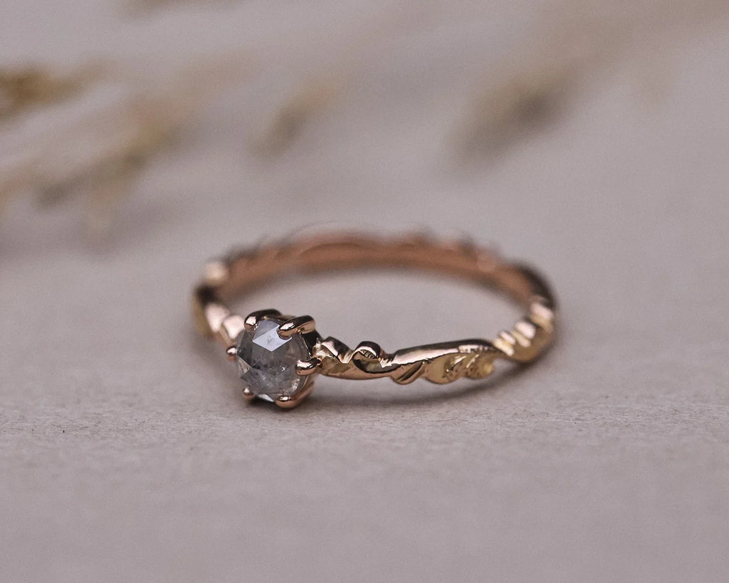 Front view of rose gold floral carved ring with pale grey rose-cut diamond