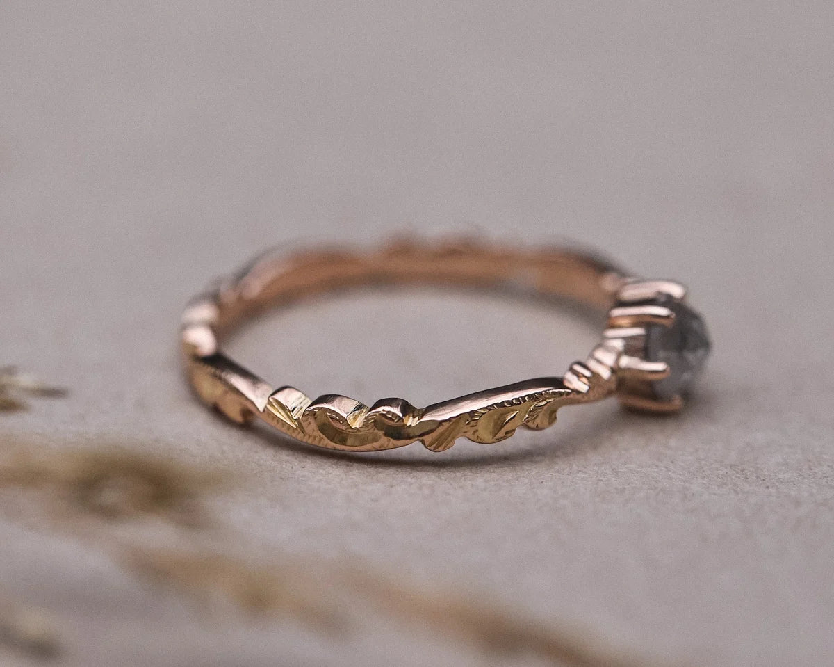 Side view of 18ct rose gold floral carved ring with pale grey diamond