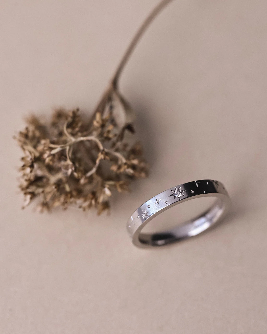 Angled view of handmade platinum star set diamond ring