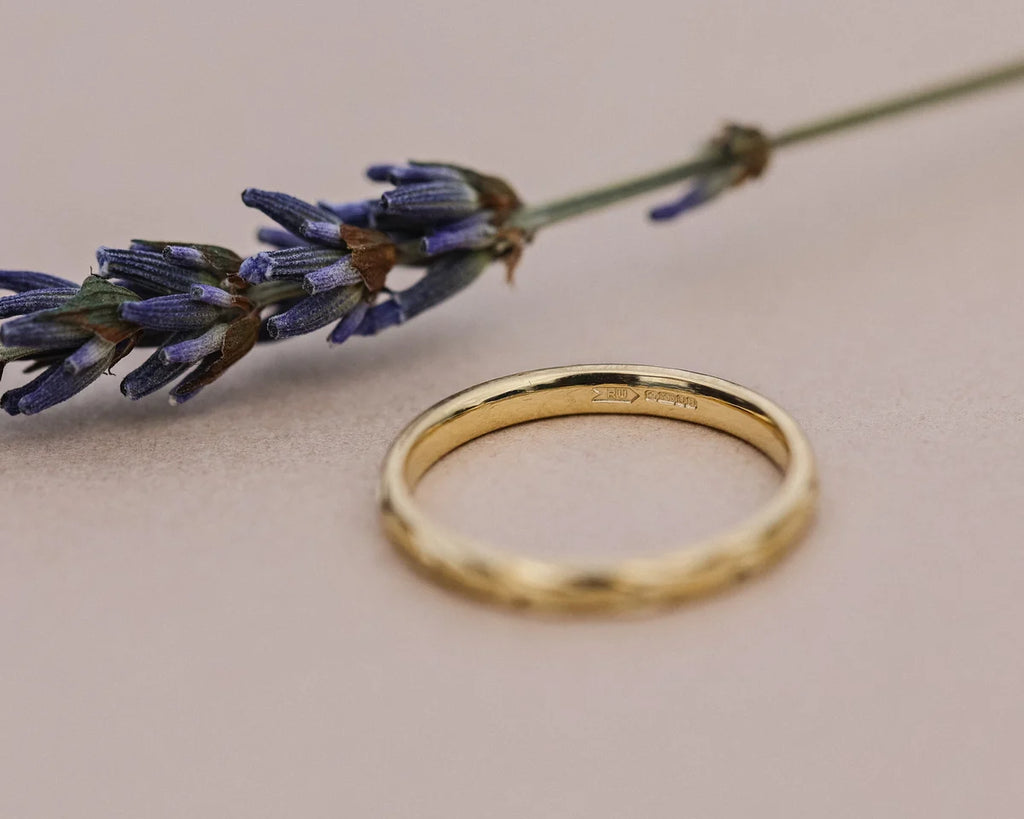Minimal yellow gold olive leaf engraved wedding band with lavender