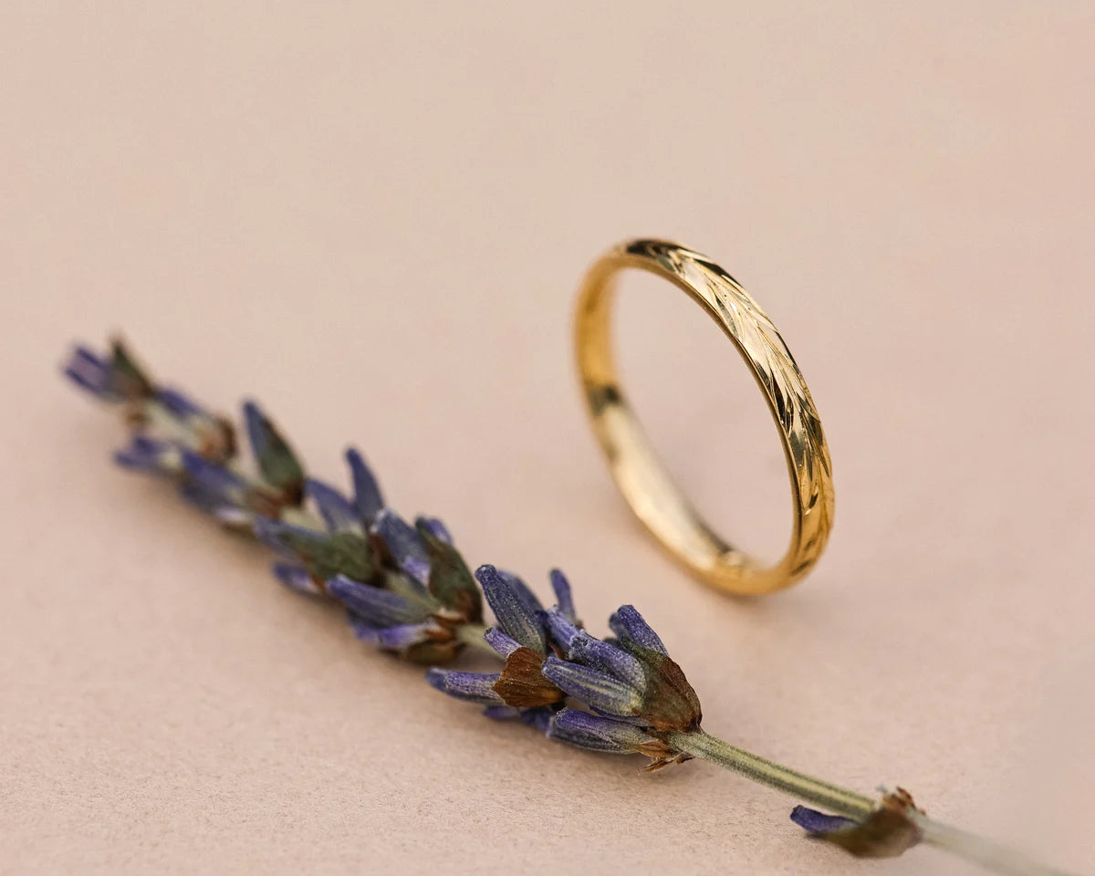 Side view of 2mm yellow gold olive leaf ring with lavender styling