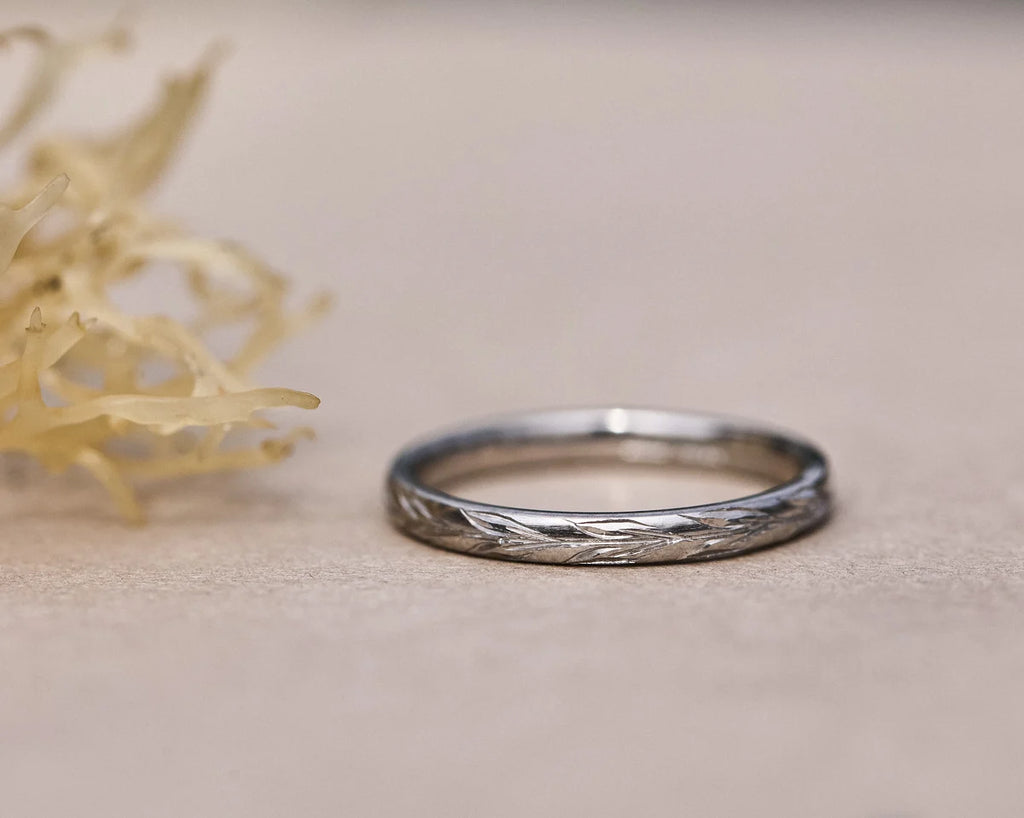 Front view of platinum olive leaf engraved wedding ring