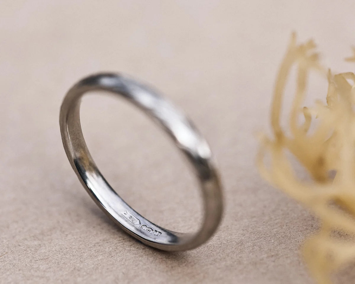 Angled view of 2mm platinum olive leaf engraved wedding ring