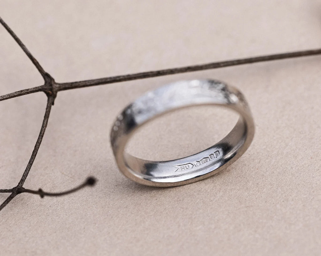 Front view of hand engraved fir ring in platinum