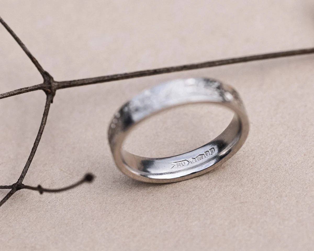 Front view of hand engraved fir ring in platinum