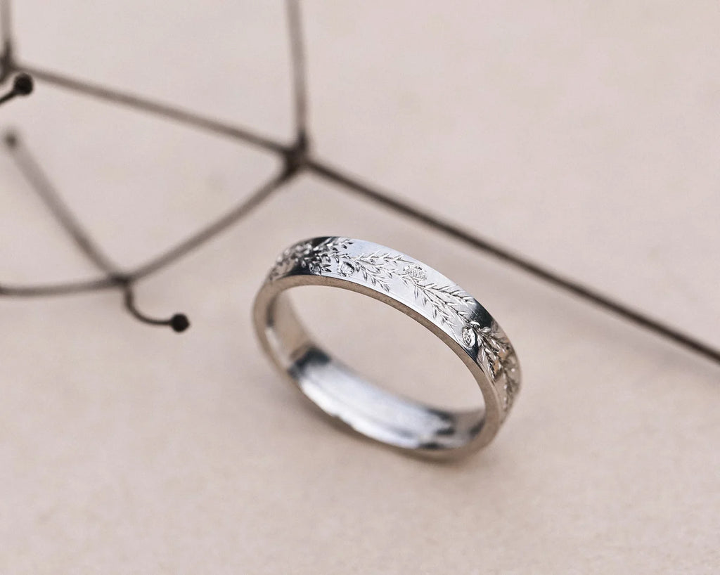 Handmade platinum wedding ring with engraved fir motif