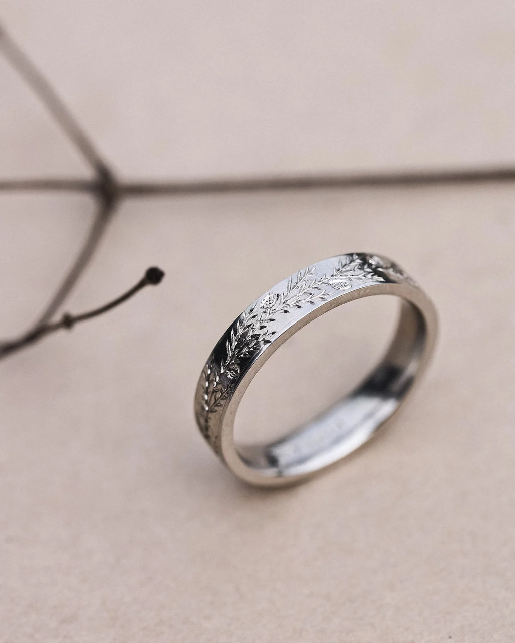 Minimal platinum fir engraved wedding ring shown upright