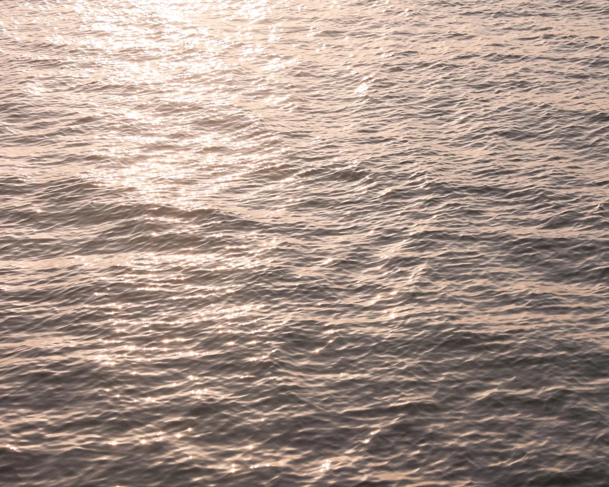 Ripple patterns on water surface with light reflection
