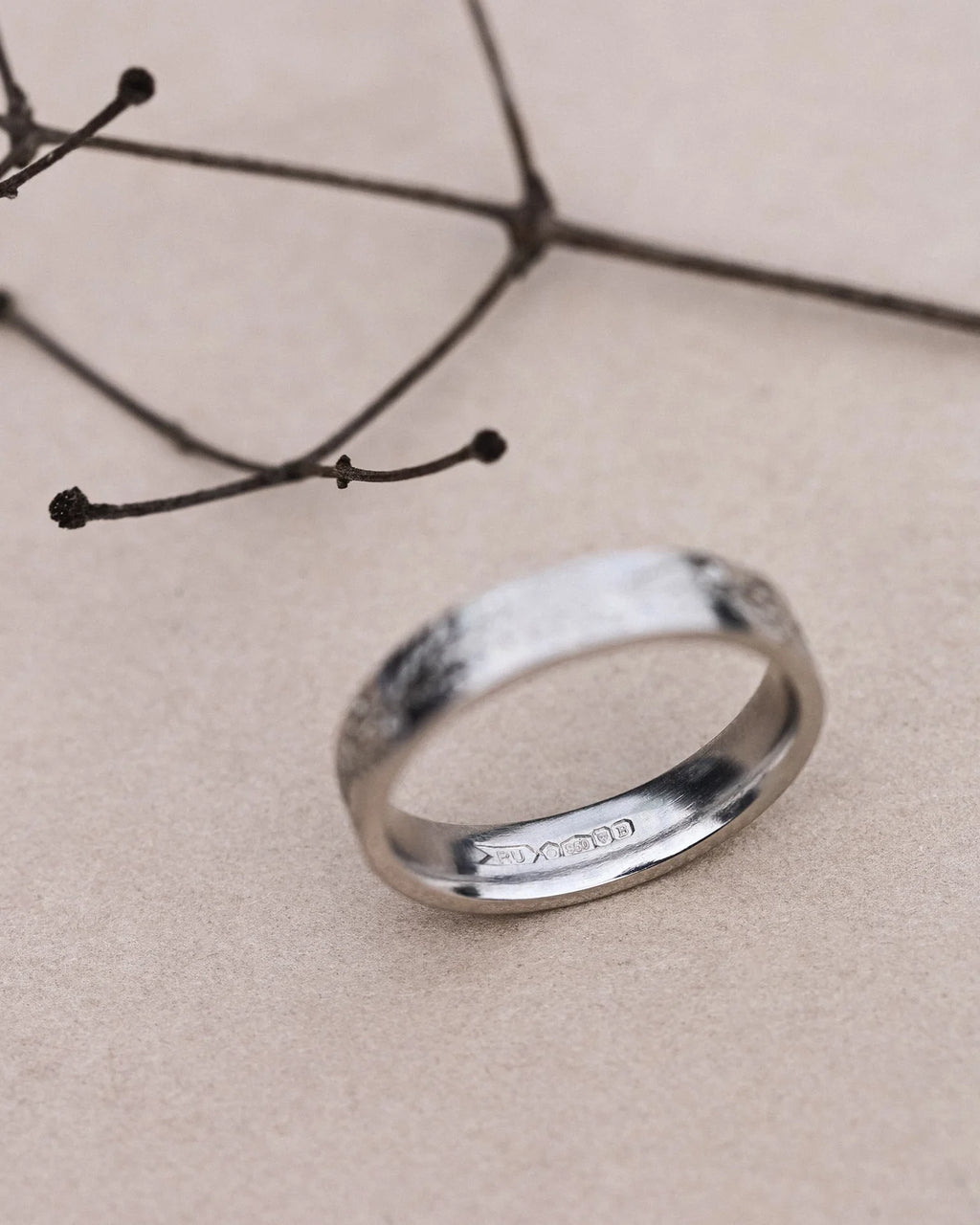 Top view of platinum fir engraved wedding band