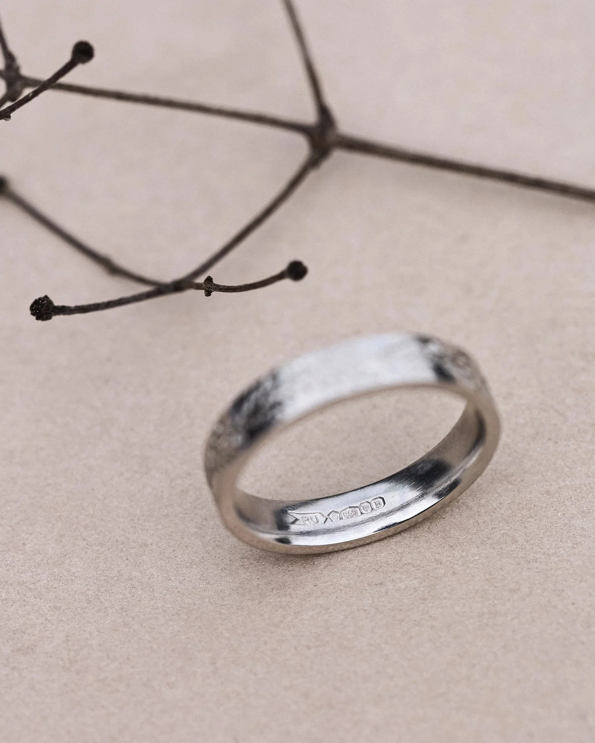 Top view of platinum fir engraved wedding band