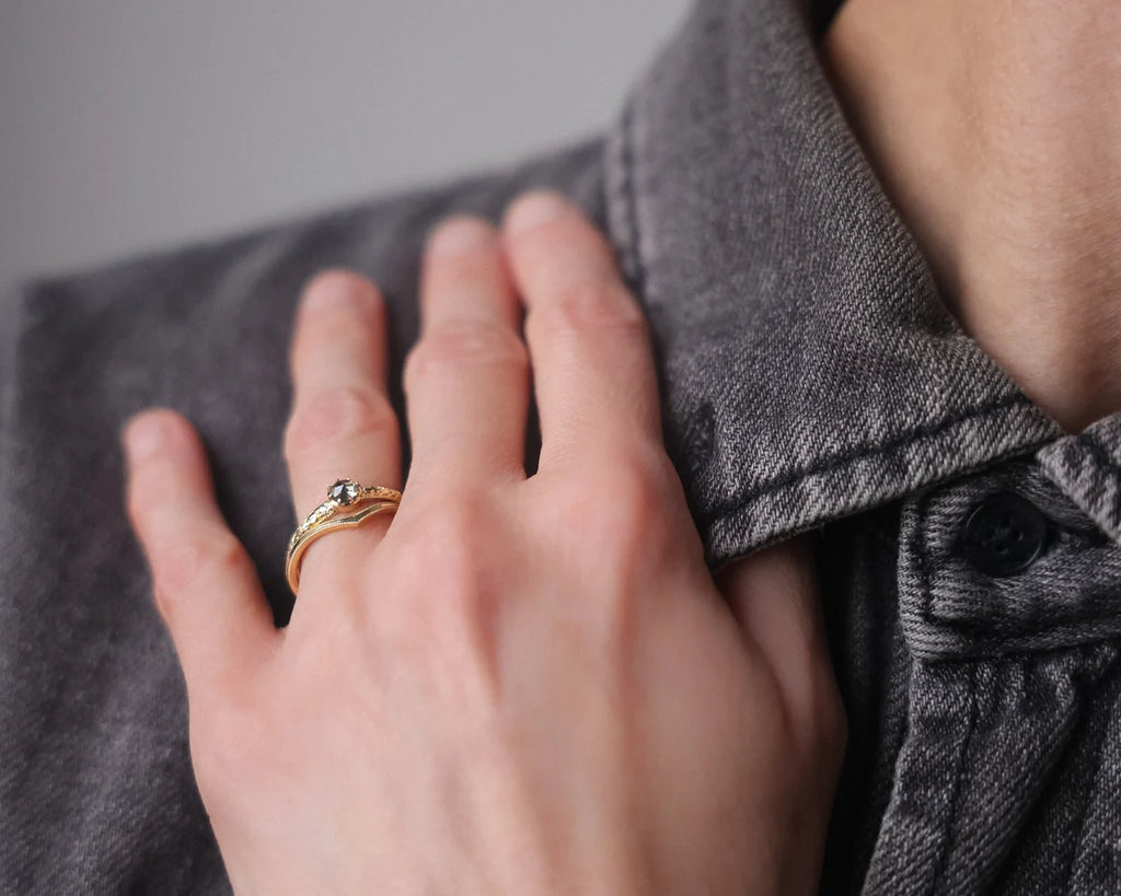Grey rose-cut diamond ring worn on hand in soft natural light