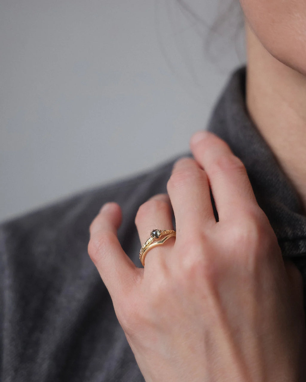 Grey rose-cut diamond ring worn on hand with editorial styling