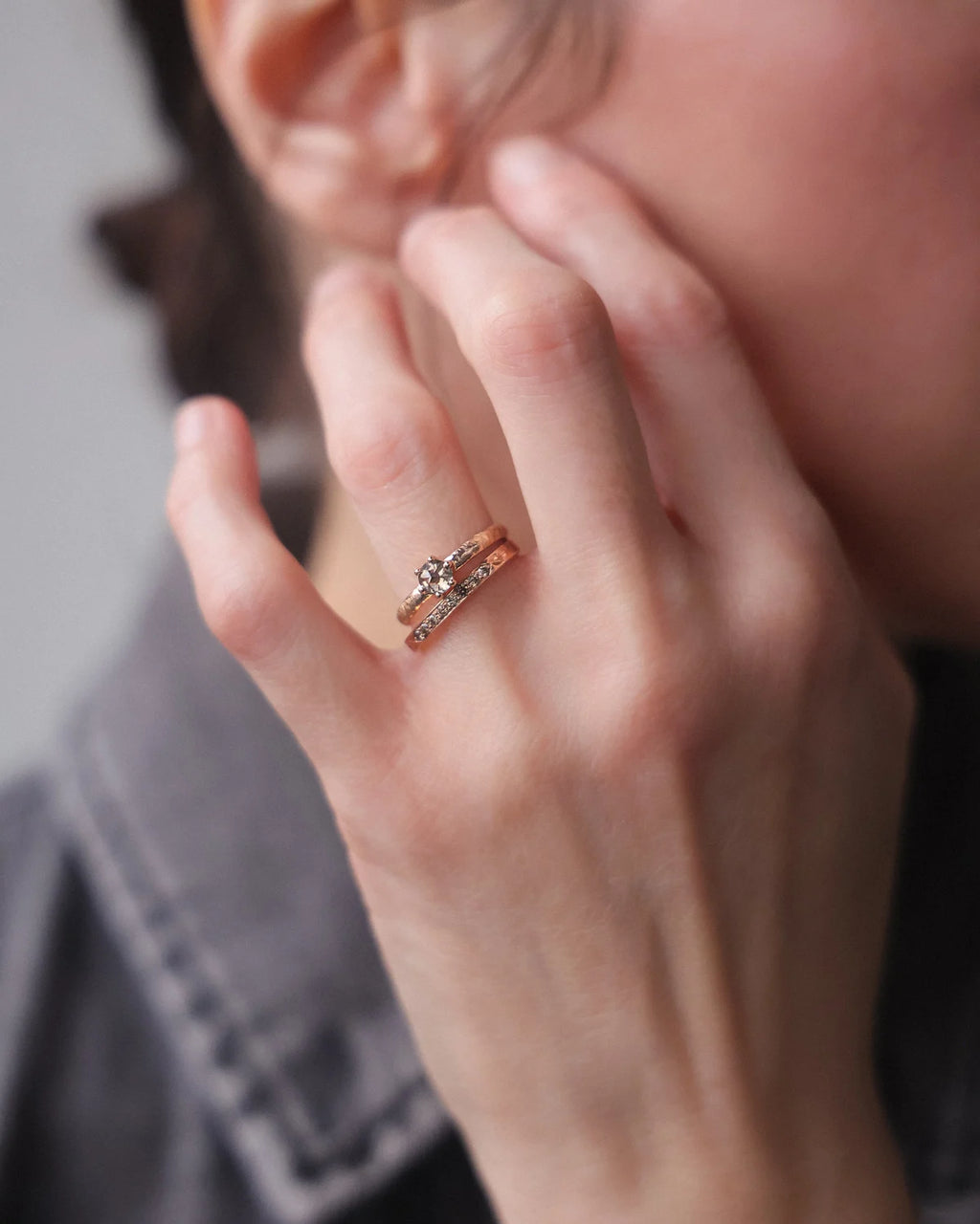 Grey rose-cut diamond ring worn on hand in soft natural light