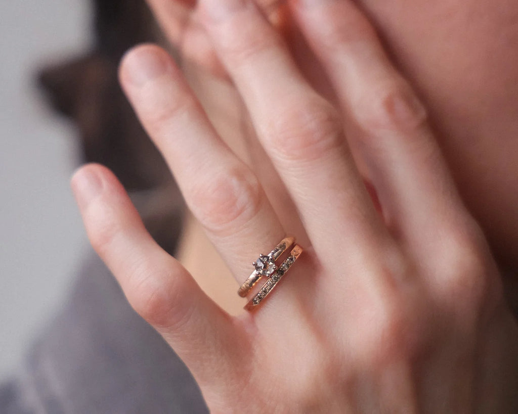 18ct rose gold horn texture ring worn with layered jewellery styling