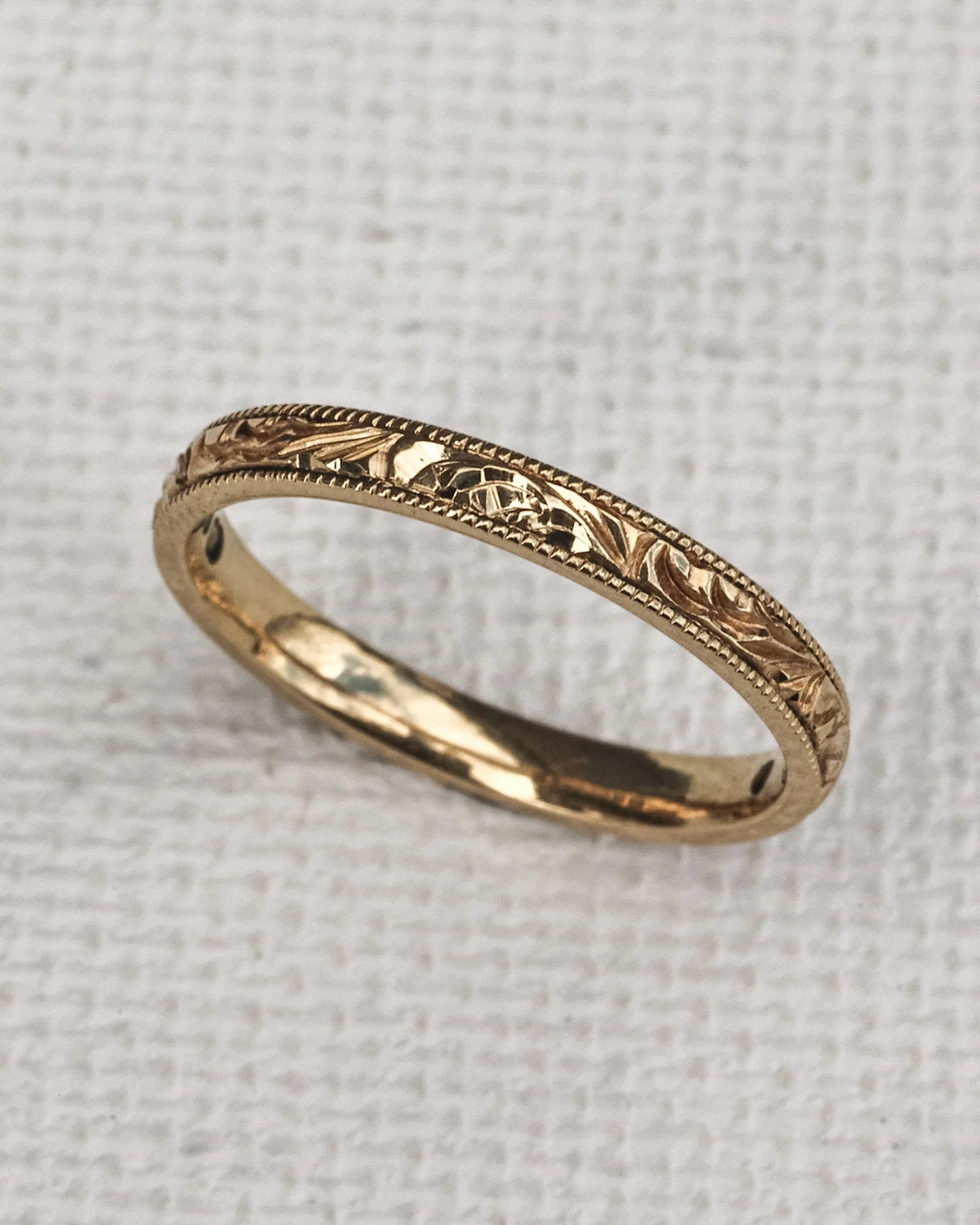 engraved floral leaf design gold band texture detail