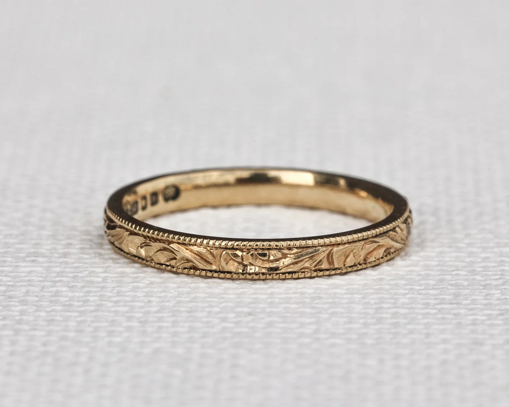engraved floral leaf design gold band texture detail