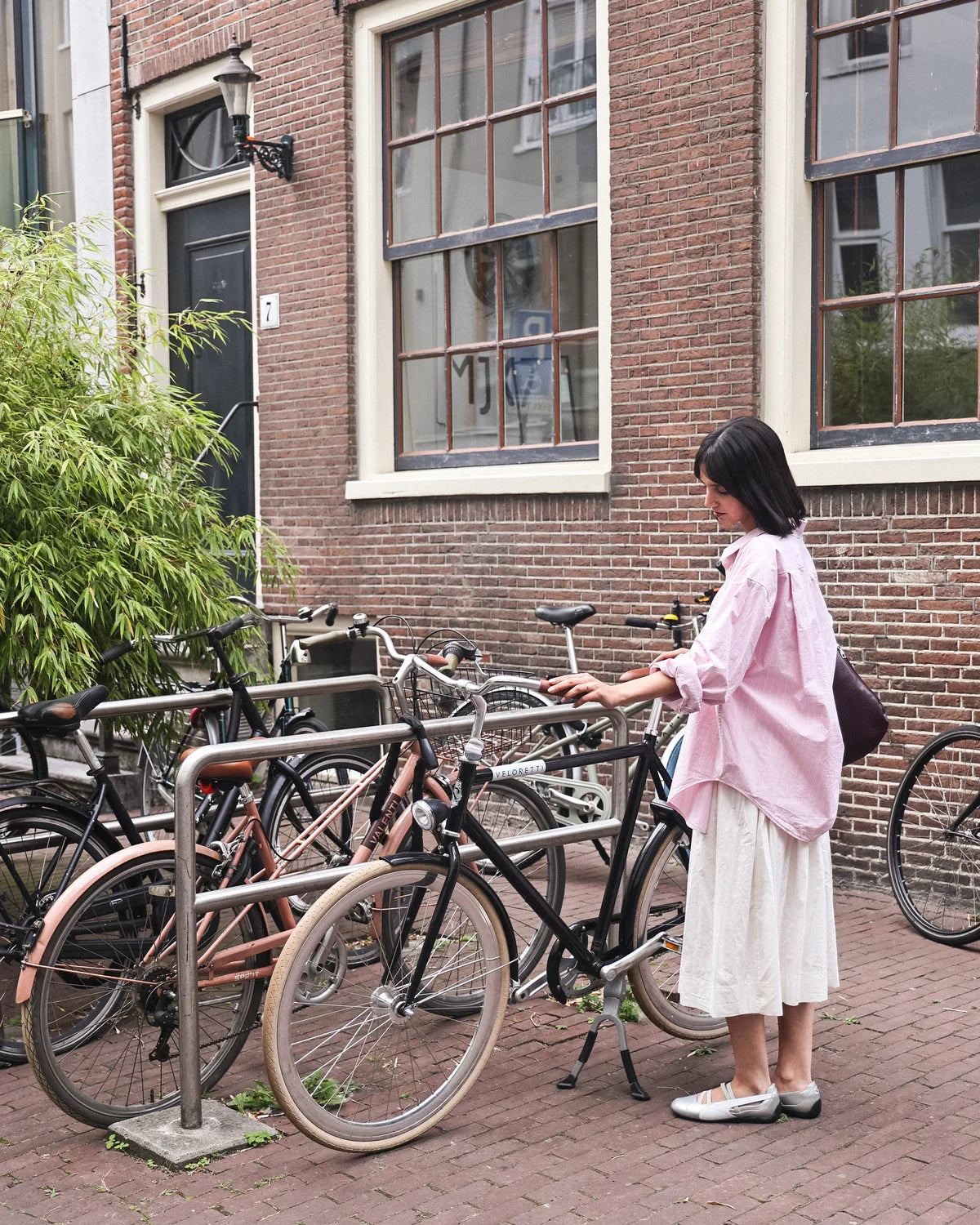 Lifestyle image of handmade rose gold wedding ring worn in city setting