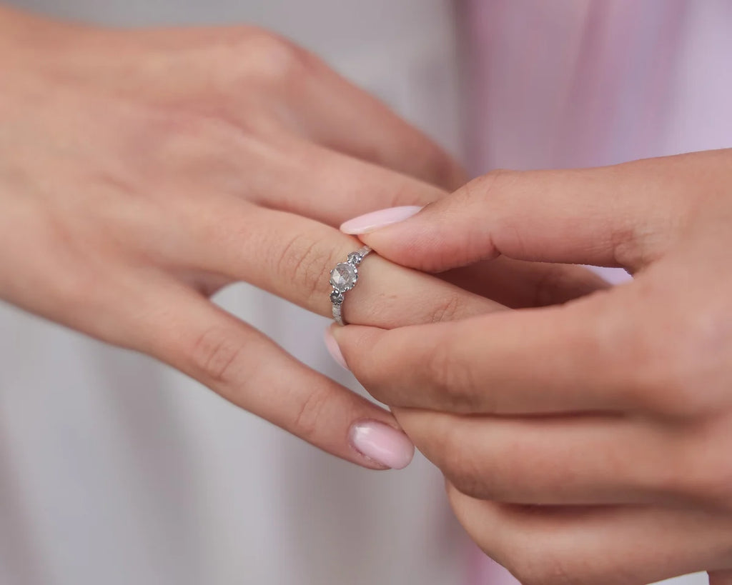 Pale grey diamond trilogy ring worn on hand