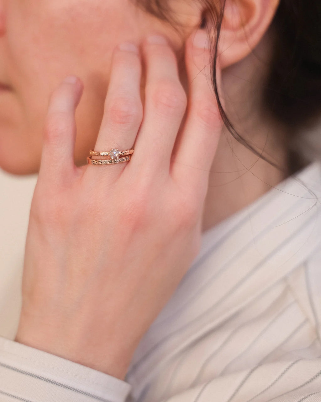 Rose-cut diamond floral ring worn on hand in soft natural light