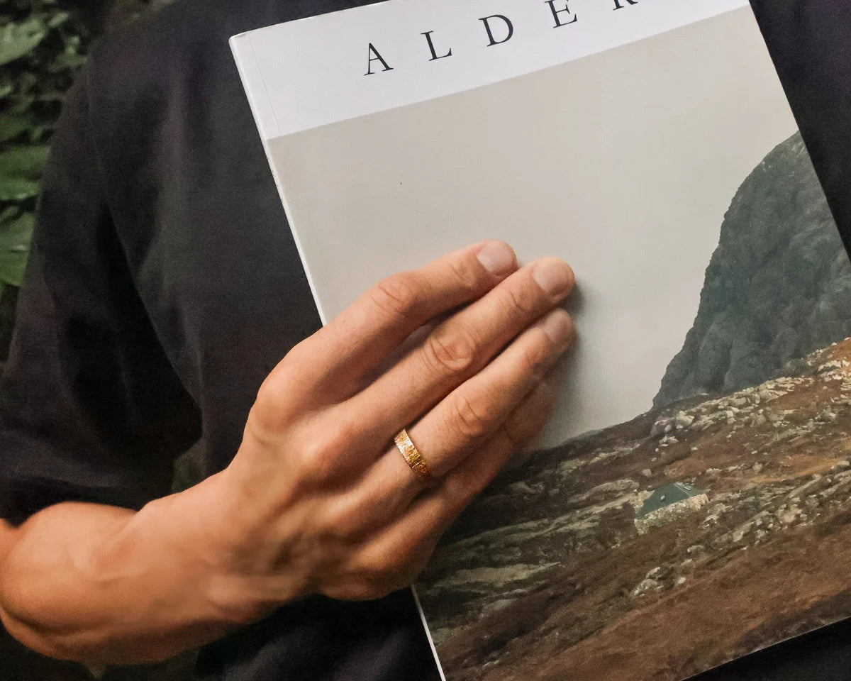 Horn texture rose gold wedding ring worn while holding art book