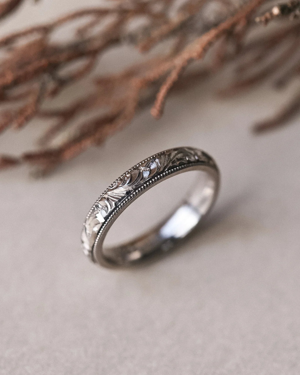 Hand engraved floral wedding ring in 18ct white gold with botanical styling