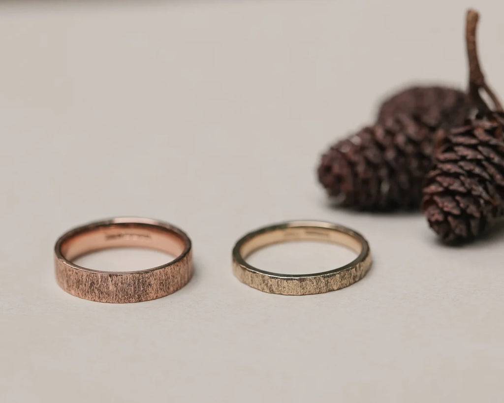 9ct rose gold horn texture ring shown beside yellow gold wedding band