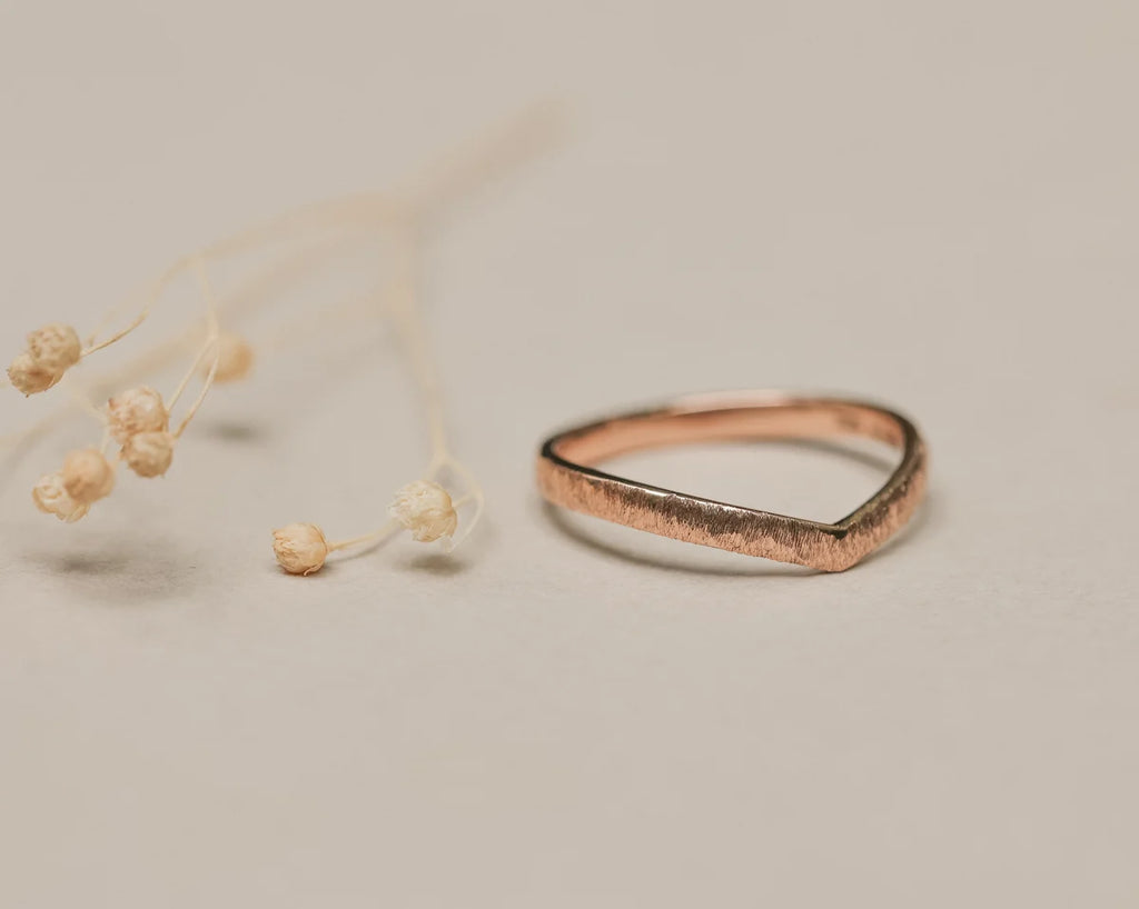 Front view of 18ct rose gold horn texture wishbone ring