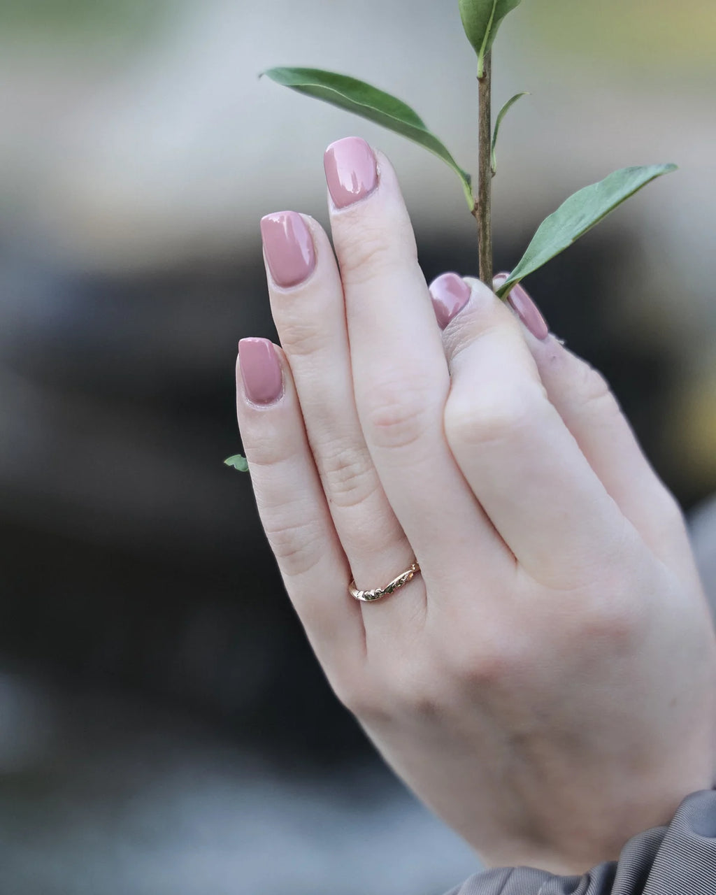 rose gold wedding ring worn on hand engraved floral band