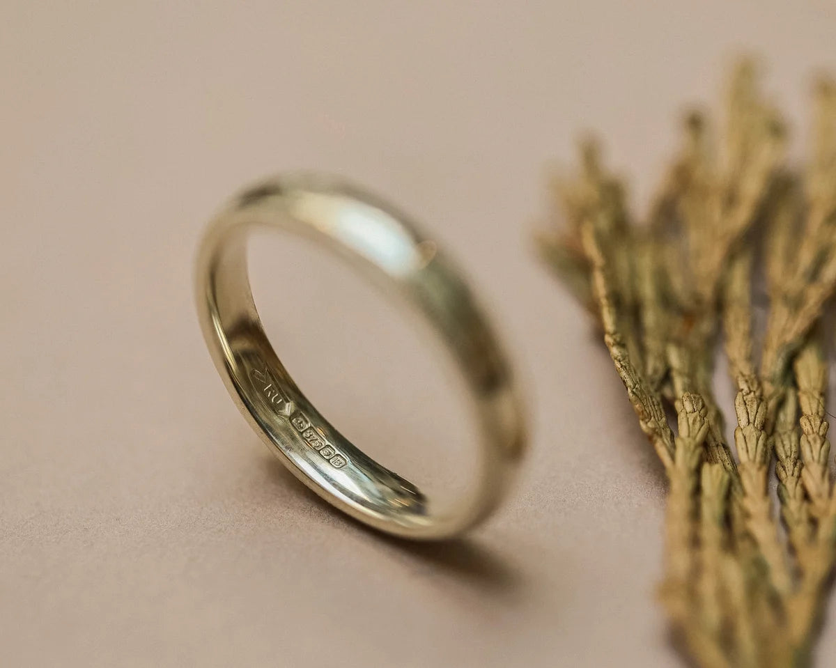 Detailed view of hand engraved milled edge on white gold band