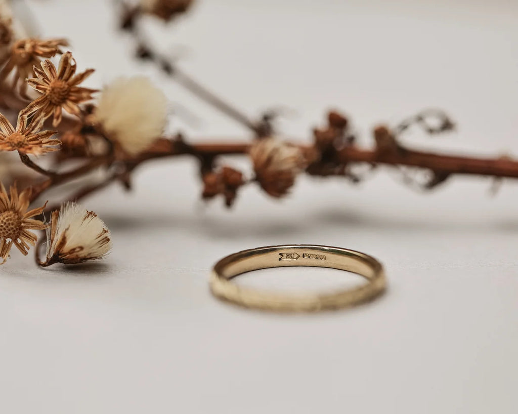 Inside view of 18ct yellow gold wedding ring with hallmark