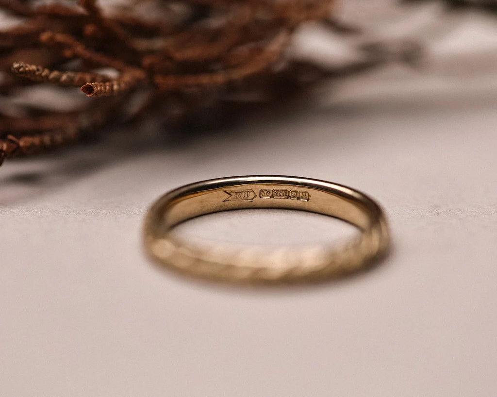 Inside view of 9ct yellow gold wedding ring with hallmark