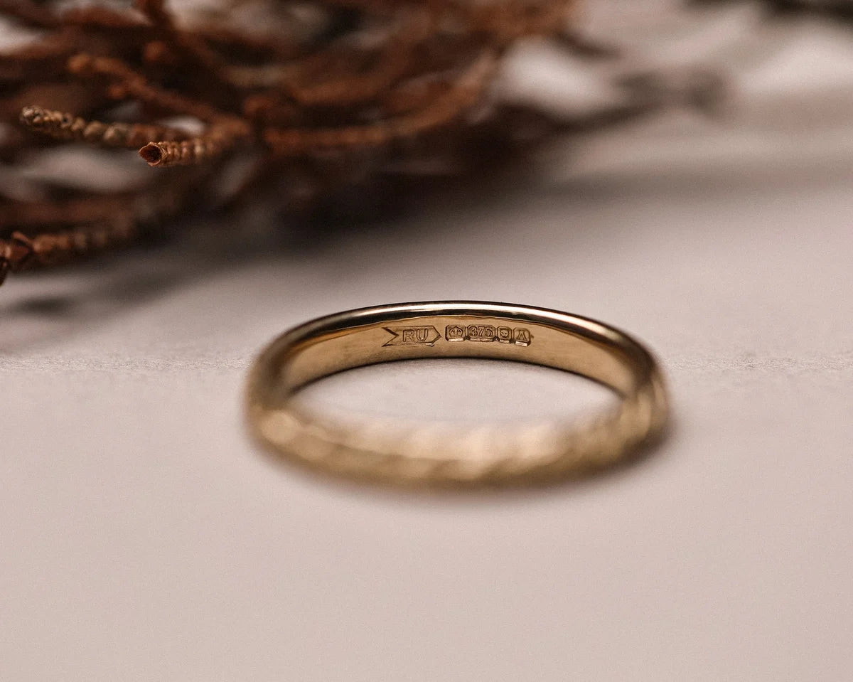 Inside view of 9ct yellow gold wedding ring with hallmark