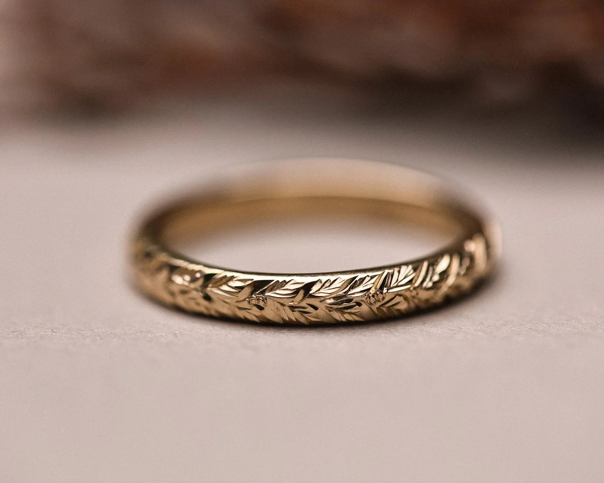 Low front view of laurel leaf engraved wedding ring in 9ct gold