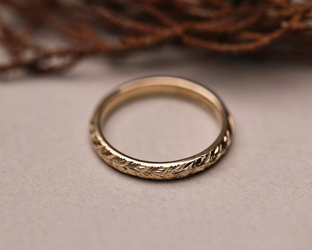Top view of handmade yellow gold laurel leaf wedding band