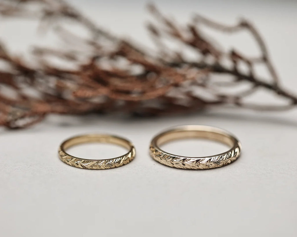 Matching laurel leaf engraved wedding rings in yellow gold