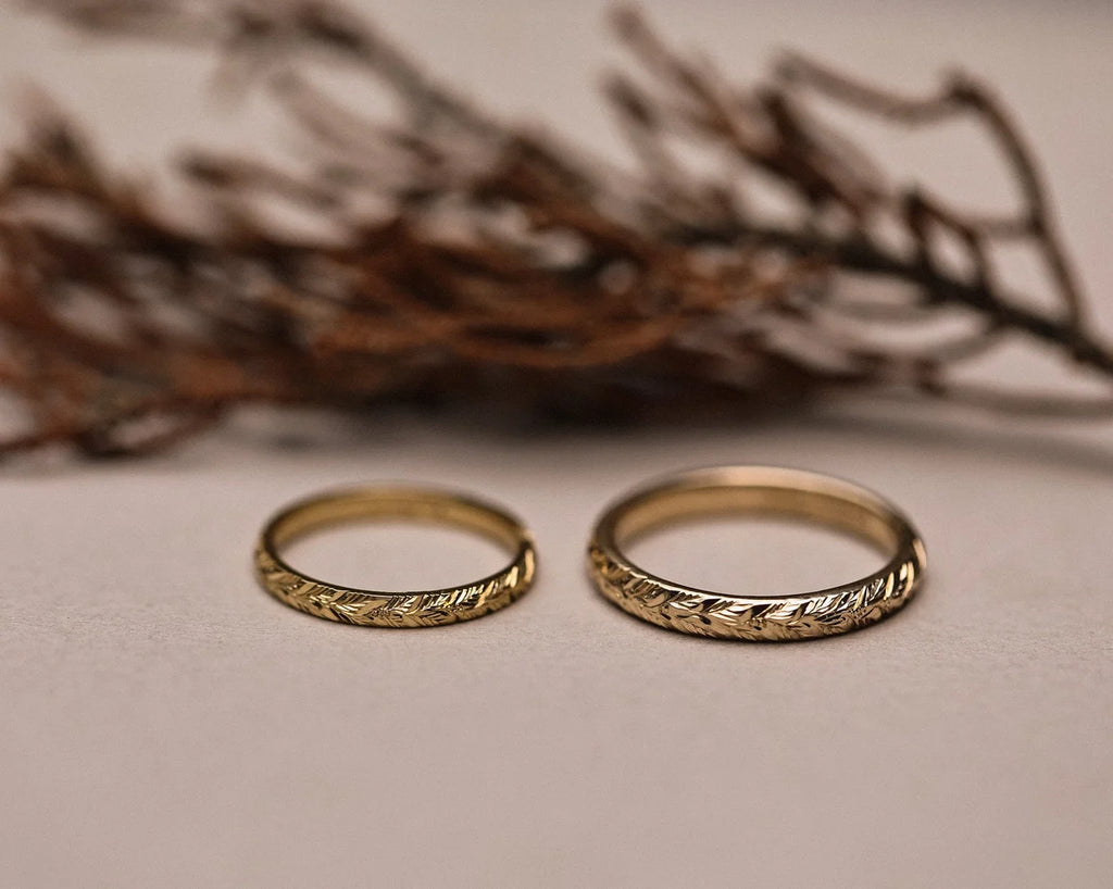 Matching laurel leaf engraved wedding rings in yellow gold