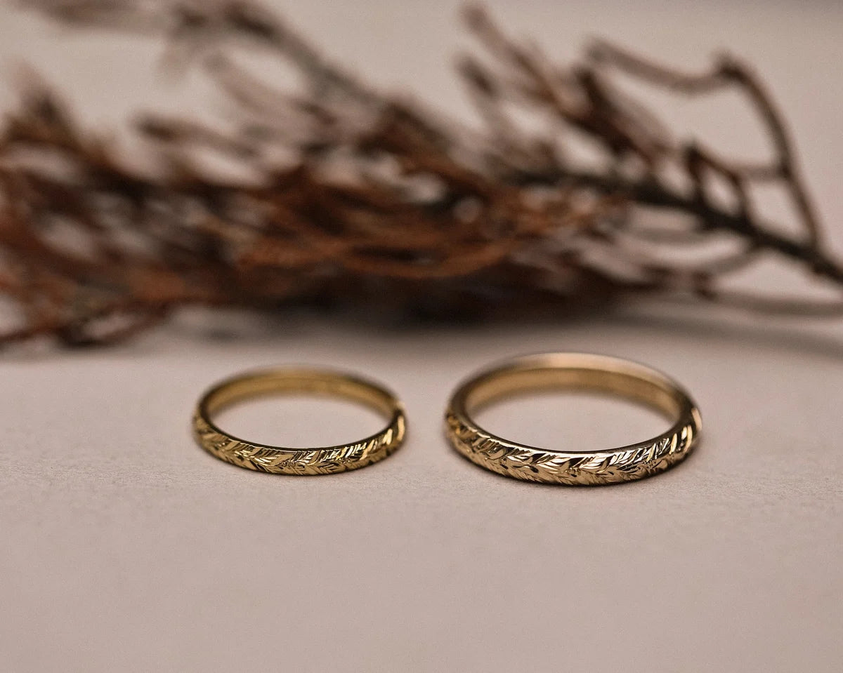 Matching laurel leaf engraved wedding rings in yellow gold