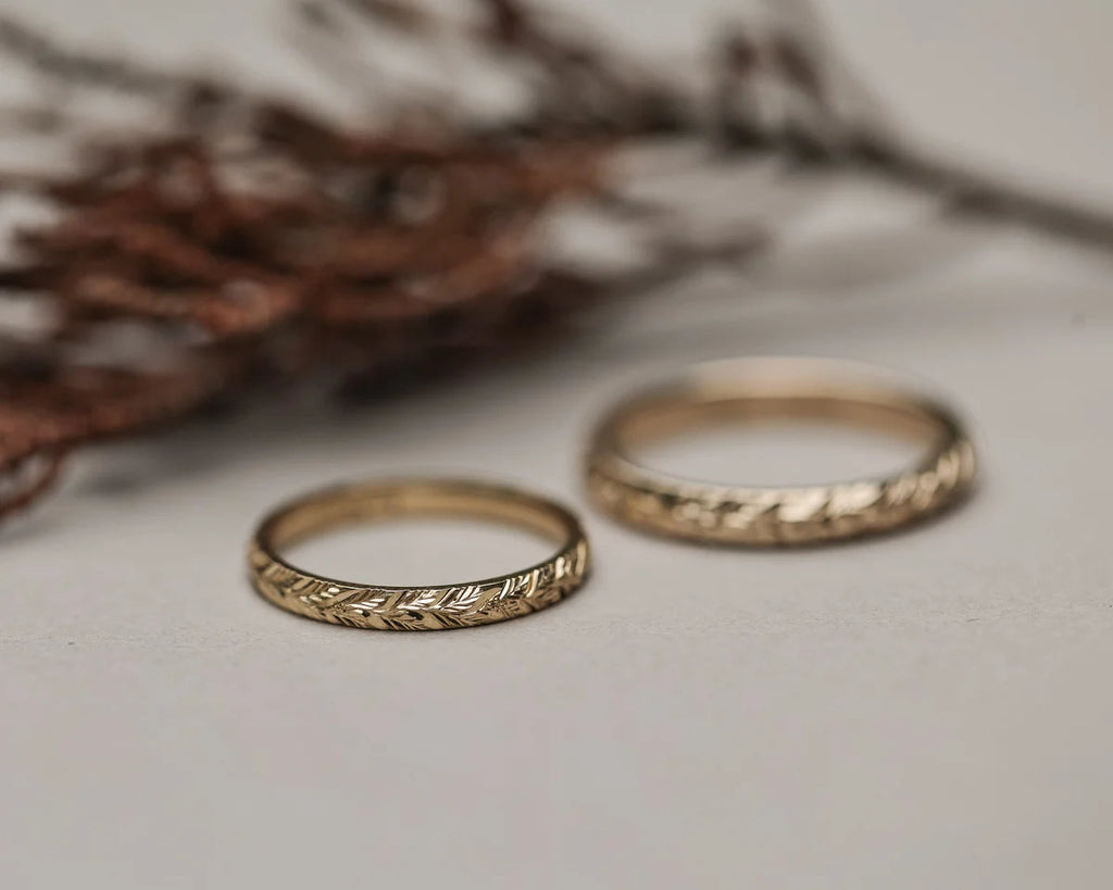 18ct yellow gold laurel leaf ring paired with wider engraved band
