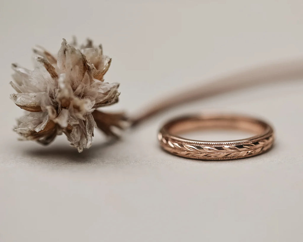 Front view of rose gold olive leaf wedding ring with fine milled edge