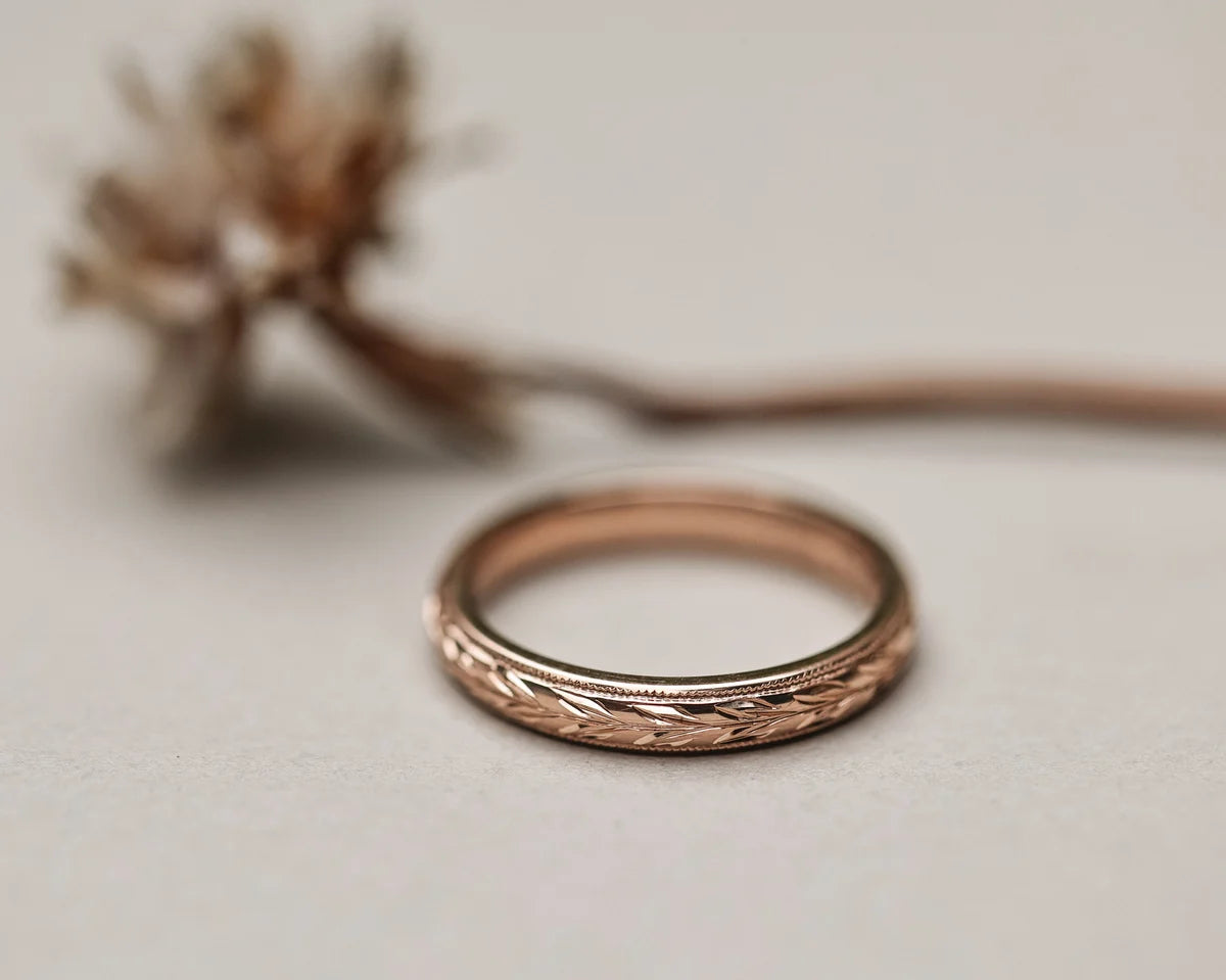 Low front view of 3mm rose gold olive leaf and milled edge ring
