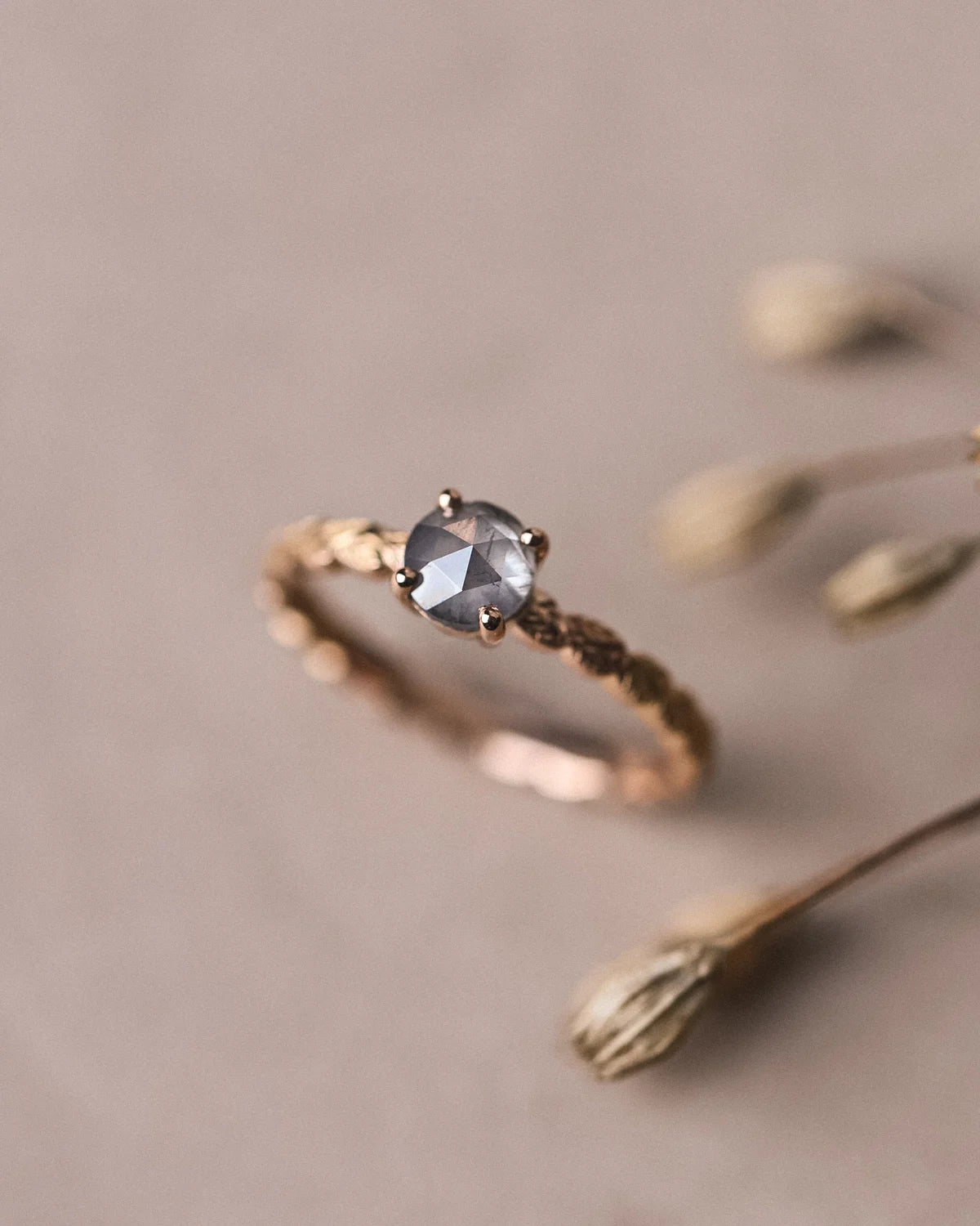18ct rose gold laurel leaf diamond ring styled with dried botanical detail
