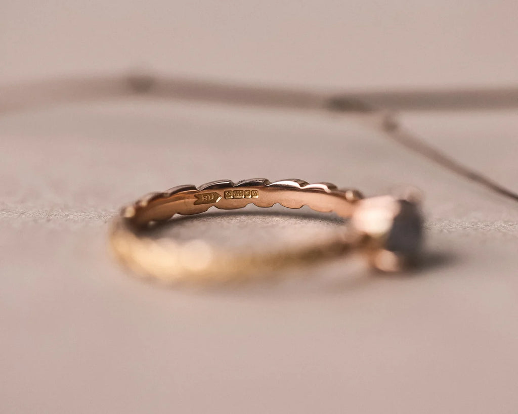 Profile view of 18ct rose gold ring with carved laurel leaf texture
