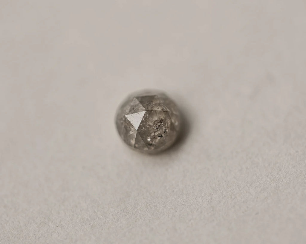 Loose pale grey rose-cut diamond on neutral background