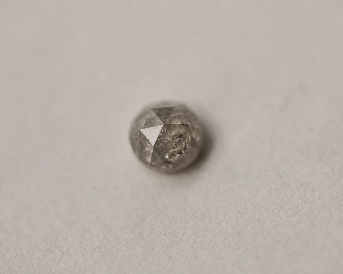 Loose pale grey rose-cut diamond on neutral background